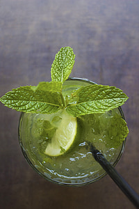 lemon juice with green leaves in clear glass cup thumbnail