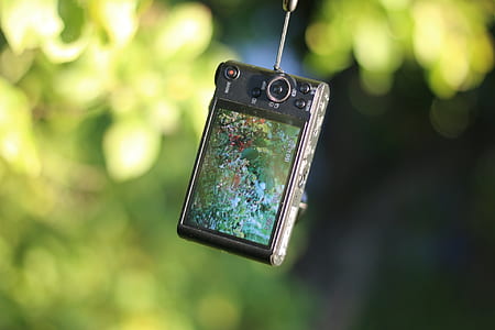 black compact camera hanging thumbnail
