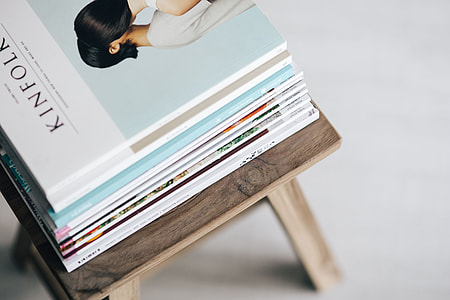 Stack of magazines on the wooden stool thumbnail