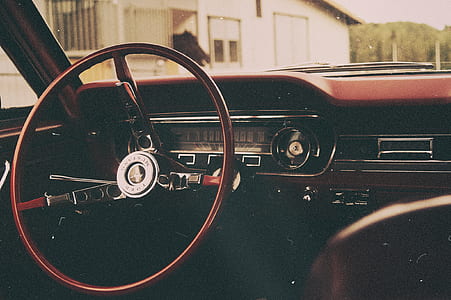 interior photo of black and brown vehicle steering wheel thumbnail
