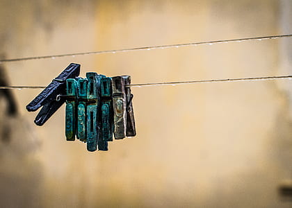blue, grey, and green clothes pin on clothes rack thumbnail