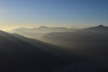 silhouette of mountains under blue sky thumbnail