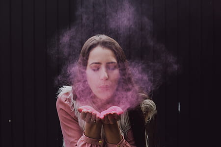 woman blowing pink powder thumbnail