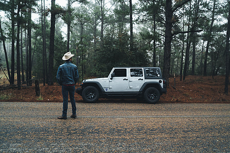 man standing near white Jeep Wrangler thumbnail