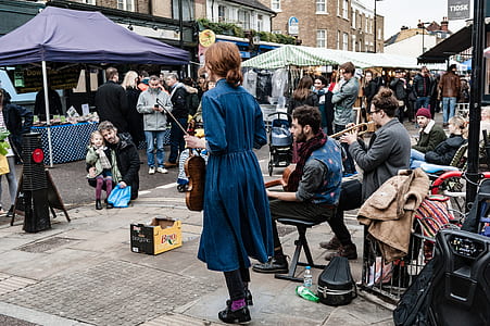 street performers performing at crowded place during daytime thumbnail