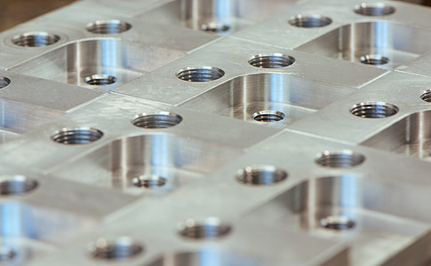 close-up photo of metal part with bolt holes thumbnail