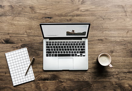 flat lay photography of laptop beside coffee mug thumbnail