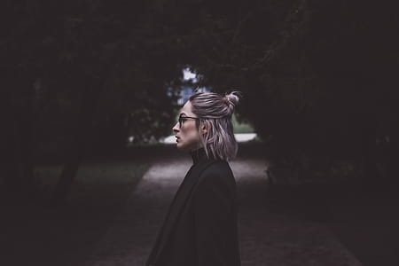 Woman Standing at the Middle of the Road Under Trees Lowlight Photography thumbnail