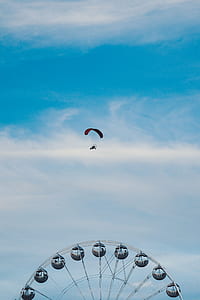person parachuting over ferris wheel thumbnail