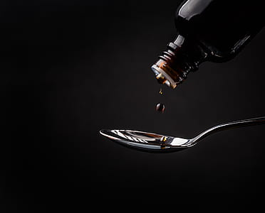 liquid from bottle about to drop to spoon thumbnail