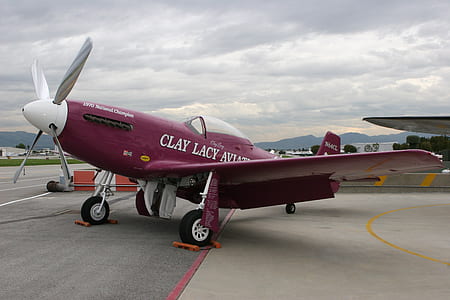 red monoplane on airport thumbnail
