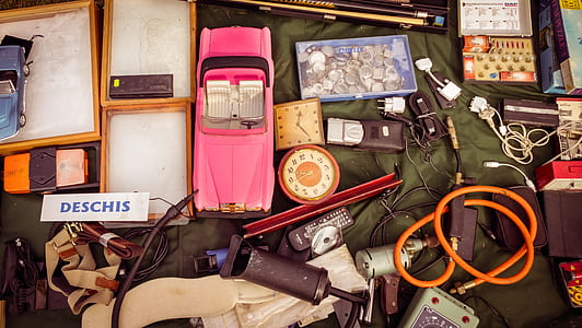 pink convertible car toy surrounded by assorted items thumbnail