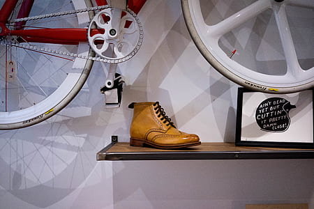 brown leather wingtip boot on floating shelf thumbnail