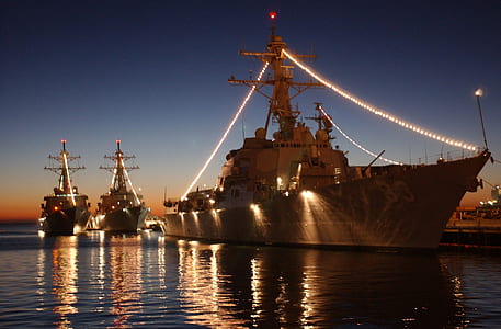 three ships with lights under blue sky thumbnail