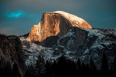 snow covered mountain under grey cloudy sky thumbnail
