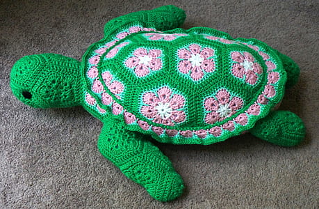 knitted green and pink turtle toy on floor thumbnail