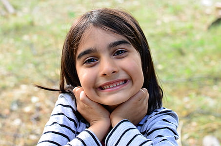 smiling girl holding her hair at daytime thumbnail