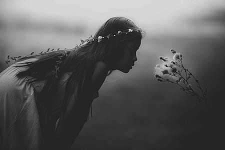 grayscale photography of girl in front of flower thumbnail