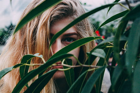 selective focus photography of woman covering on green plant thumbnail