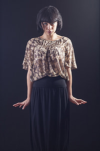 Woman wearing brown floral blouse and black maxi skirt thumbnail