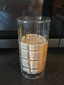 clear drinking glass filled with white liquid thumbnail
