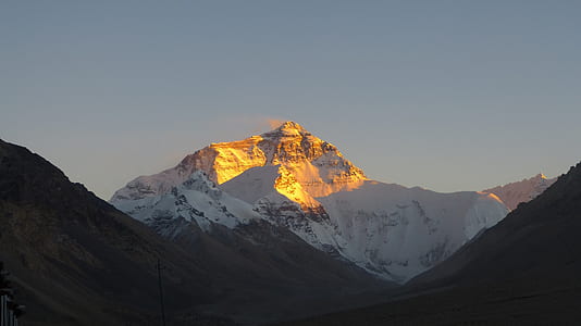 snow capped mountain under pale evening sky thumbnail