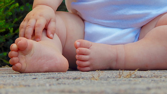 toddler's white shirt sits on gray concrete surface thumbnail