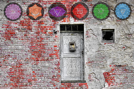 gray metal door and gray and red wall bricks at daytime thumbnail