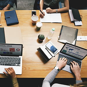 flat-lay photography of four person sitting around table thumbnail