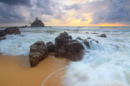 Rock on Beach Shore With Waves Crashing during Cloudy Daytime Sky thumbnail
