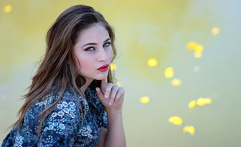 selective focus photography of woman wearing blue and black top thumbnail