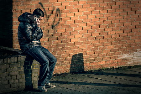 man sitting while calling thumbnail