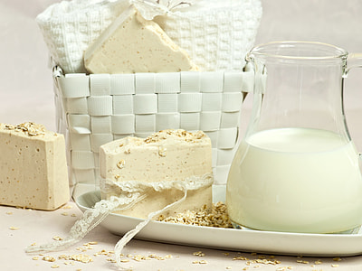 half filled milk on pitcher near cheese and basket thumbnail