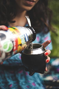 Woman Holding Gray and Black Container thumbnail