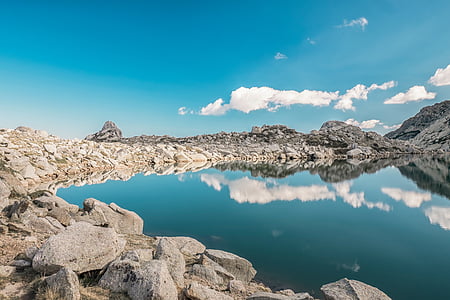 rocks near body of water at daytime thumbnail