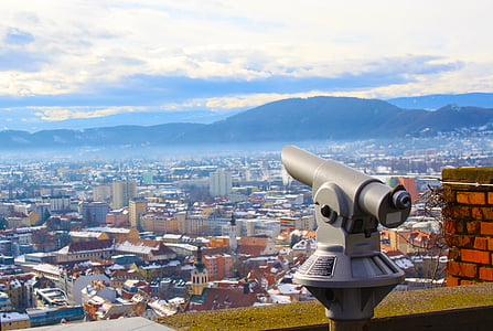 gray telescope near city at daytime thumbnail