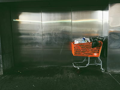 orange shopping cart beside silver steel wall thumbnail