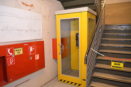 yellow telephone booth beside the stairs thumbnail