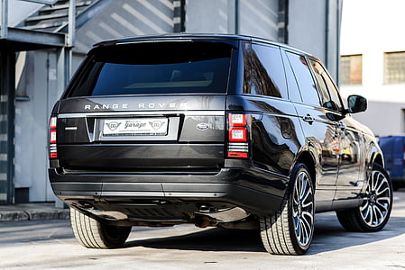 gray Land Rover Range Rover SUV parked near white concrete building thumbnail