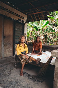 Woman Wearing Yellow V-neck Shirt Sitting Beside Man thumbnail