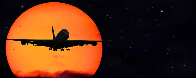 silhouette of airplane flying in the sky during nighttime thumbnail