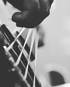 grayscale photo of person playing string instrument thumbnail