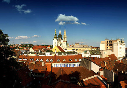 white cathedral surrounded by buildings thumbnail