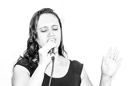 grayscale photo of woman singing thumbnail