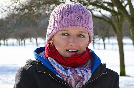 smiling woman wearing purple knit cap and scarf thumbnail