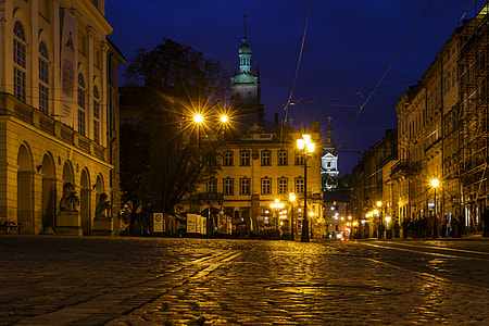 view of white 3-storey building at night time thumbnail