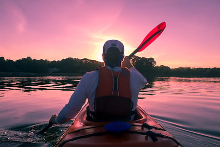 man rowing kayak boat towards land thumbnail