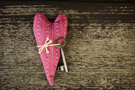 silver key attached on heart pillow thumbnail