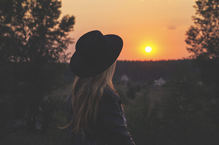 woman standing looking at the sunset thumbnail