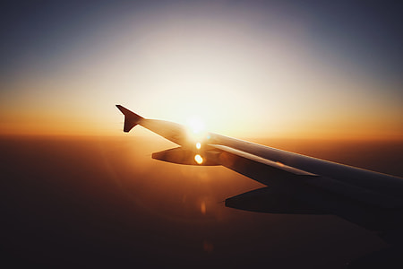 white plane flying in the sky thumbnail